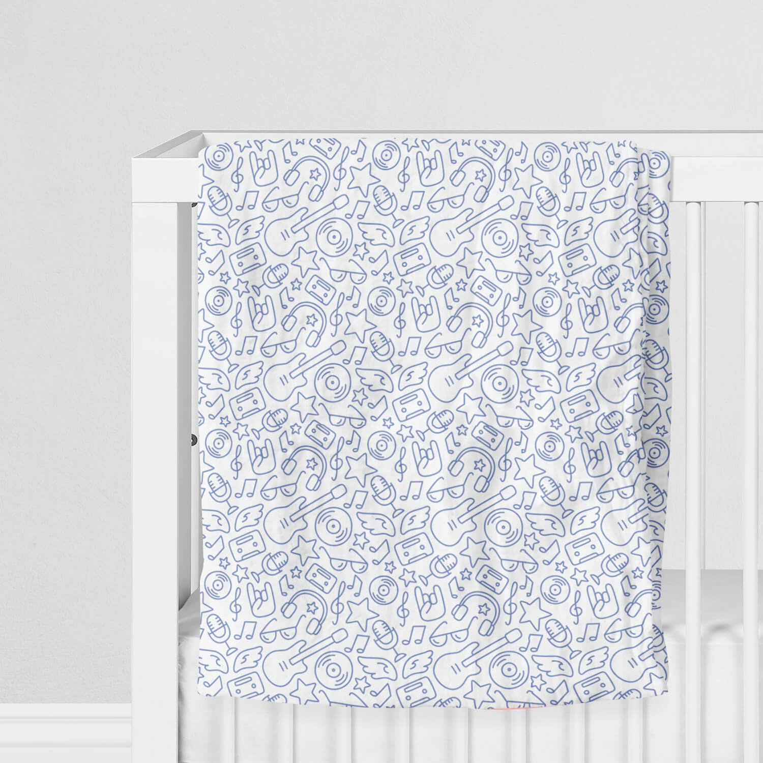100% Muslin Cotton Swaddle Blanket with Rock 'N' Roll pattern on crib