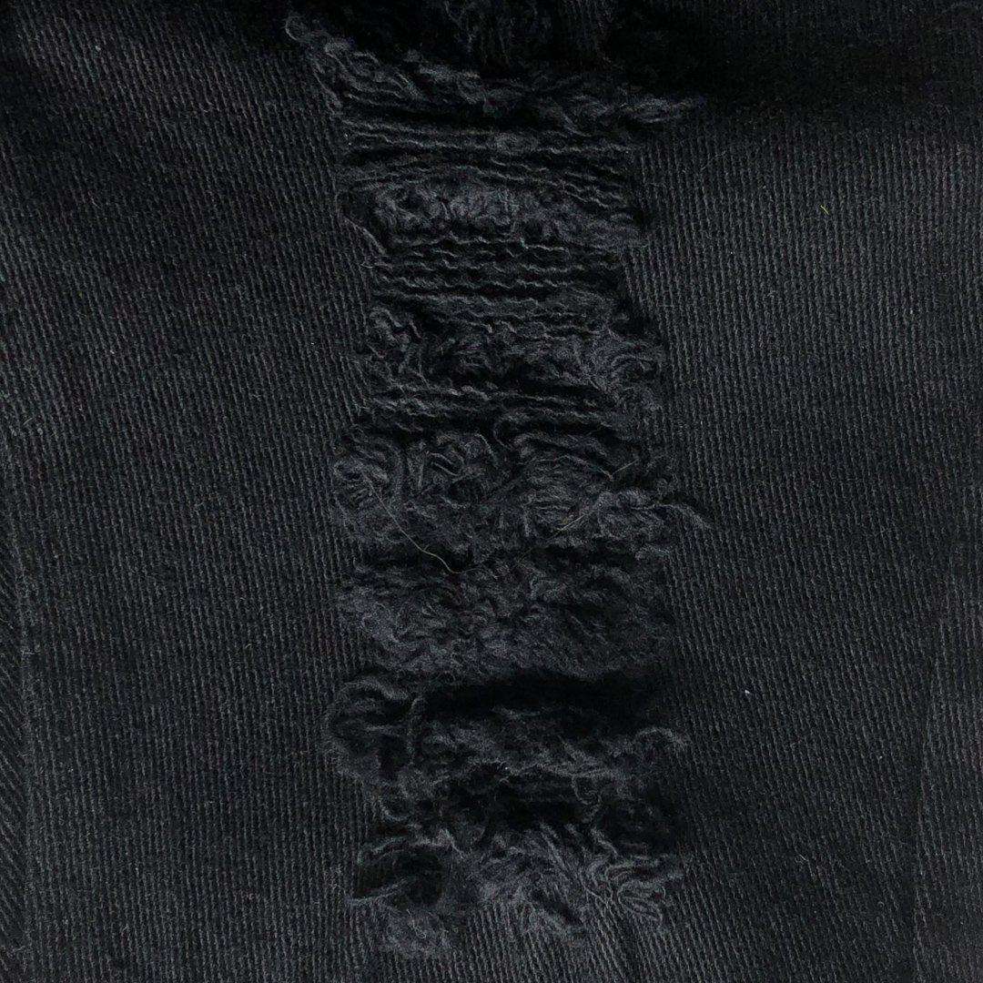 Kids jeans black ripped denim close up detail