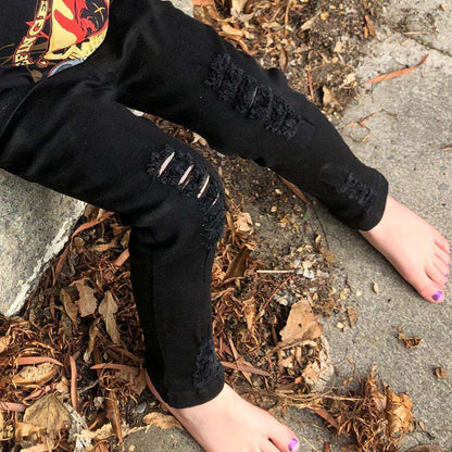 Kids jeans black ripped denim knee details on model