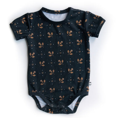 Baby romper onesie with hearts and roses pattern in black and gold