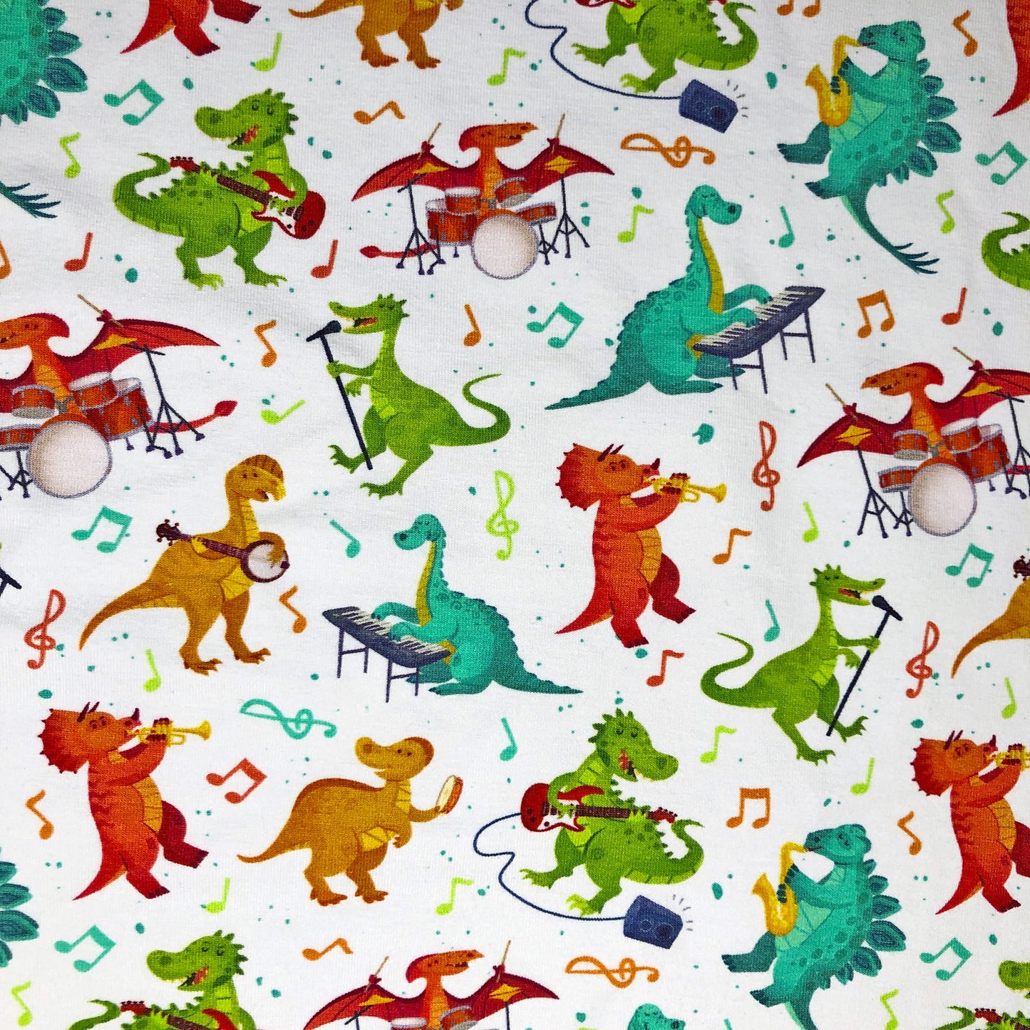 Colourful dinsaurs playing instruments on a white background